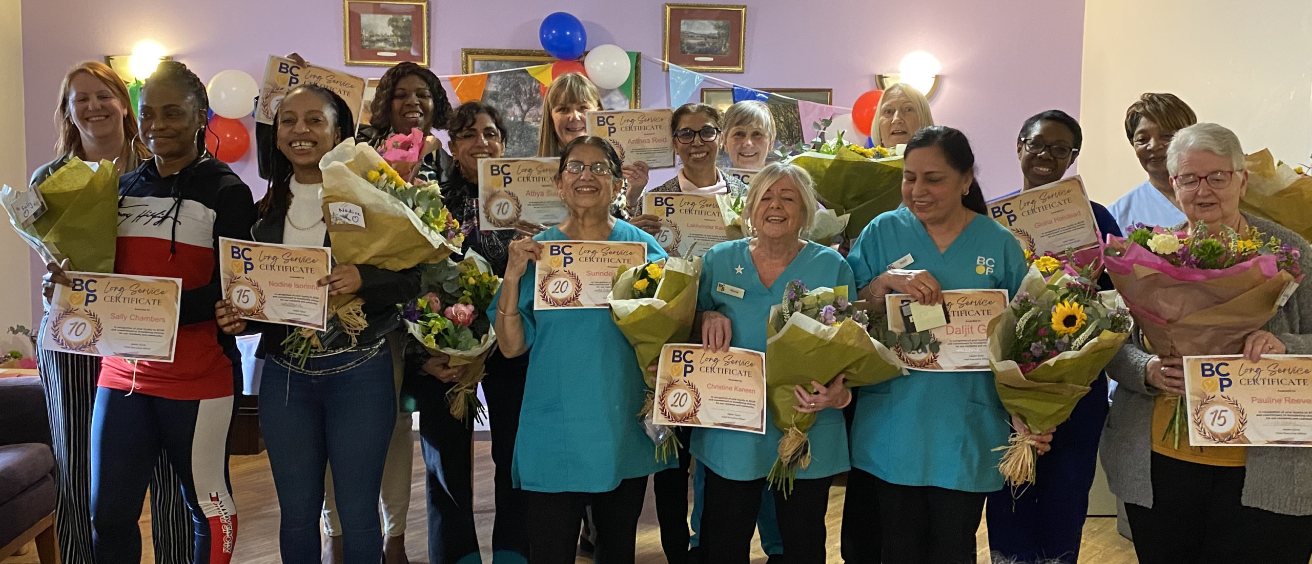 Robert Harvey House staff receiving their long service awards in February 24