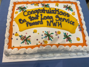 The large celebration cake for Neville Williams House long-serving staff