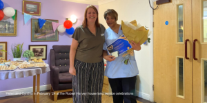 Helen Gore presenting Cynthia with her long service award at Robert Harvey House