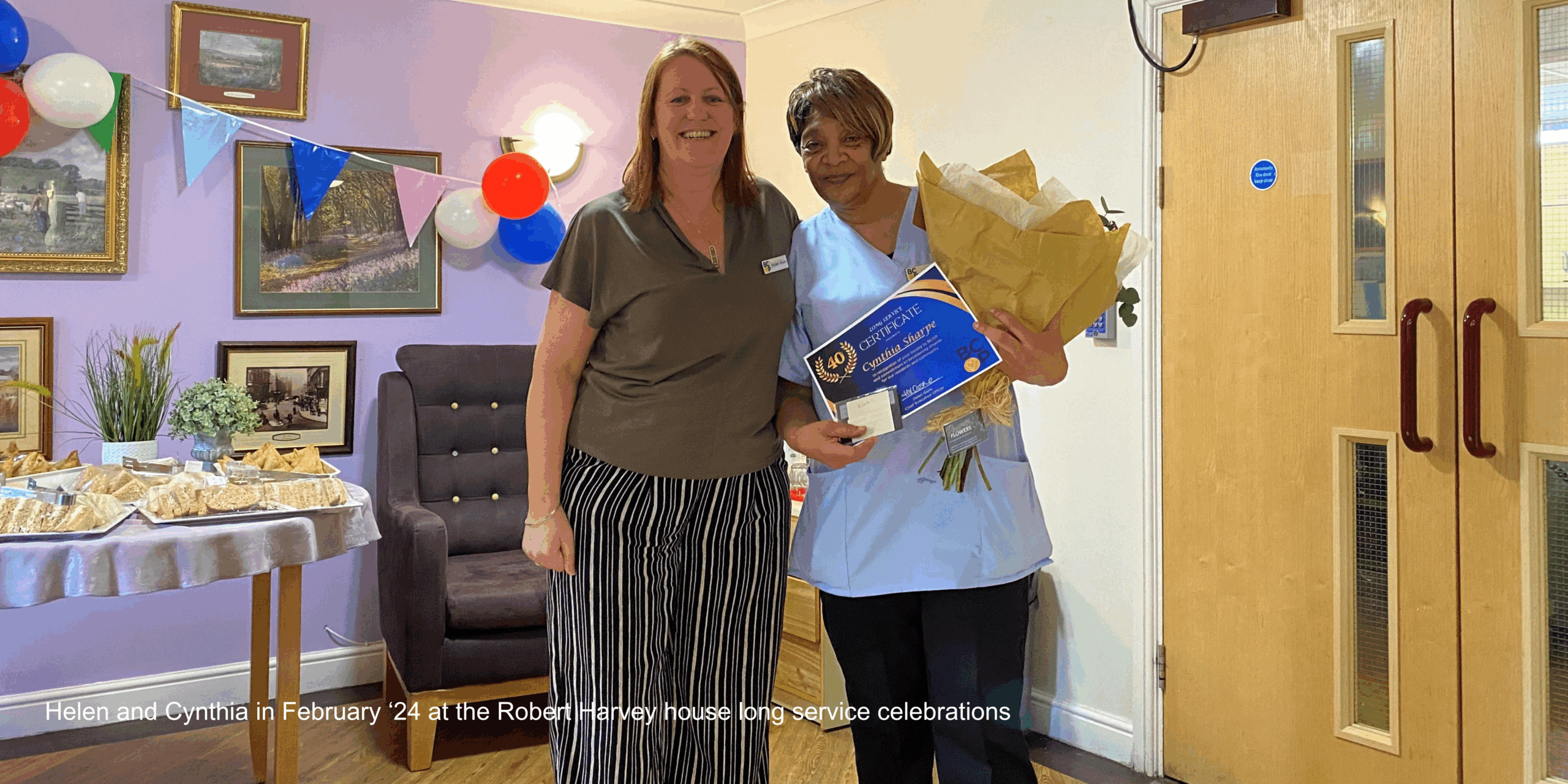 Helen Gore presenting Cynthia with her long service award at Robert Harvey House