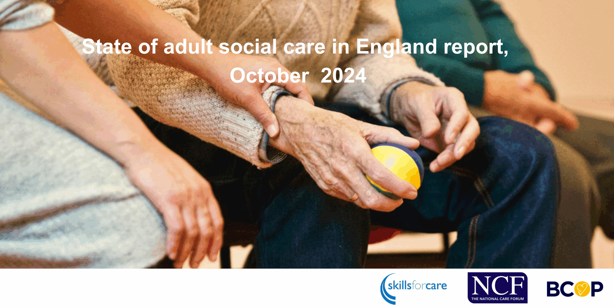 Image of a care worker holding the hand of an older person