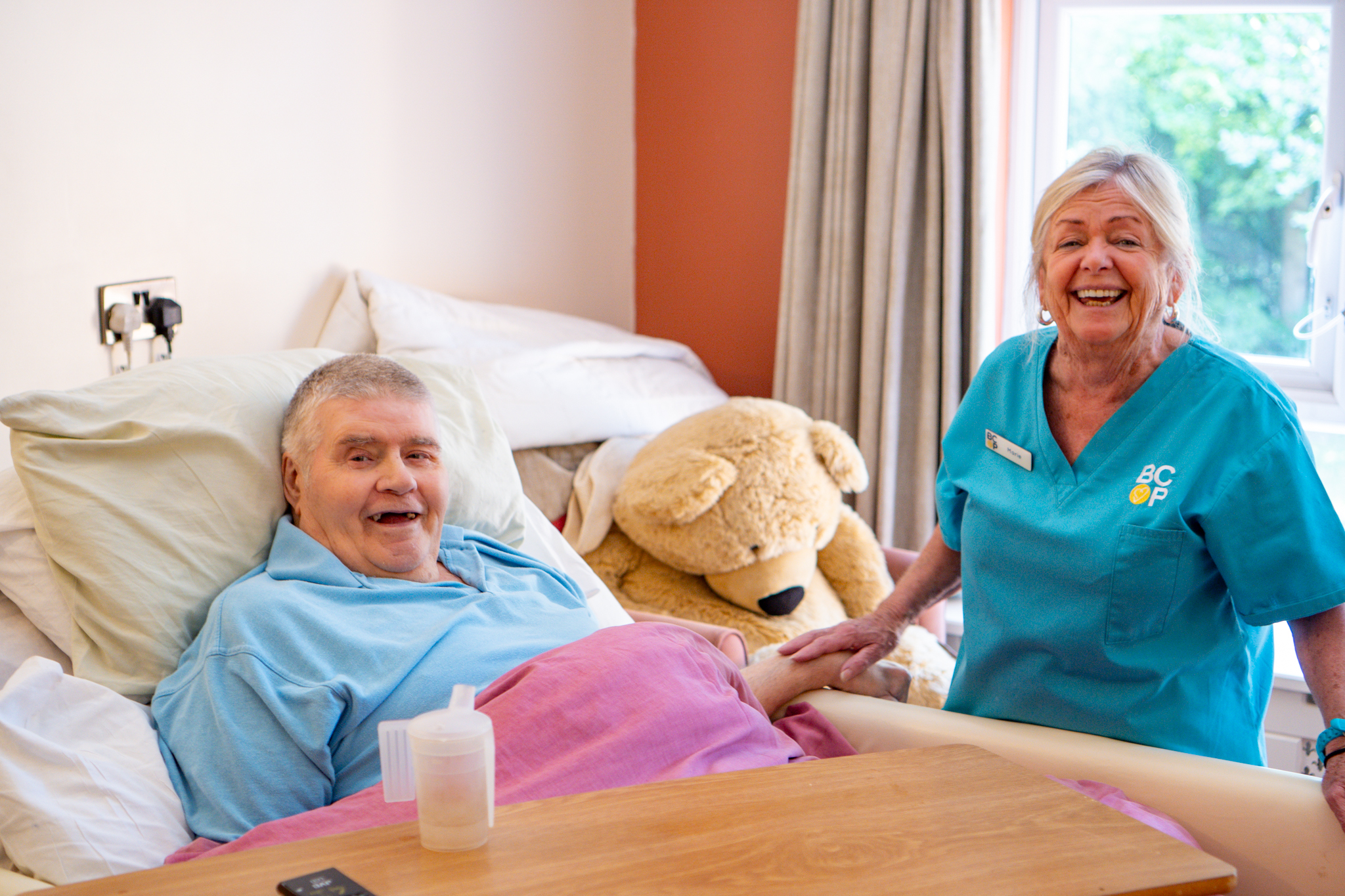 Staff and resident share a smile at Robert Harvey House