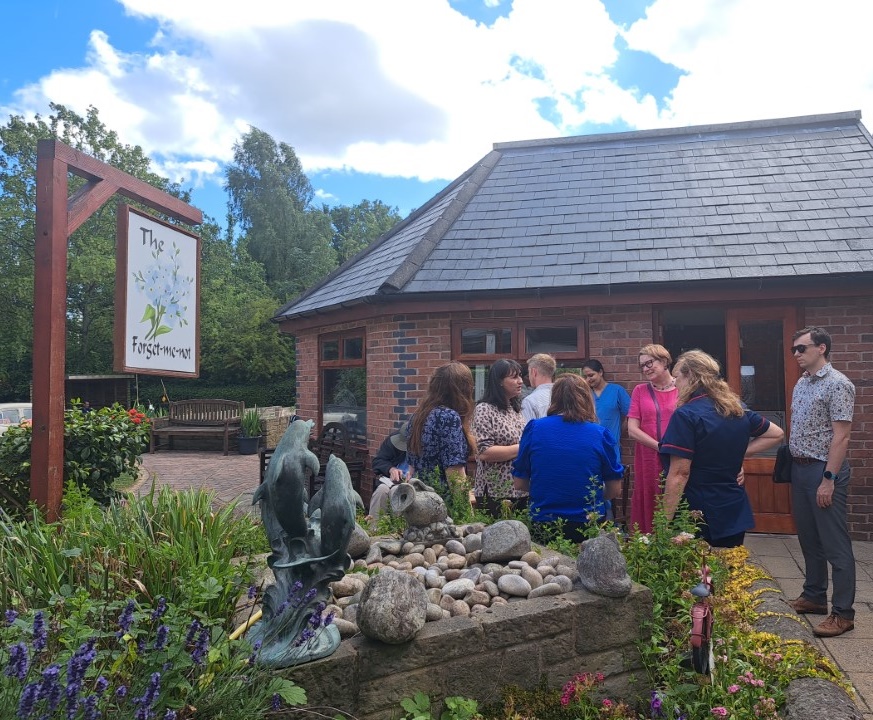 Staff, residents and families meet the caey Commission team and the NCF team at Neville Williams House in June 2025