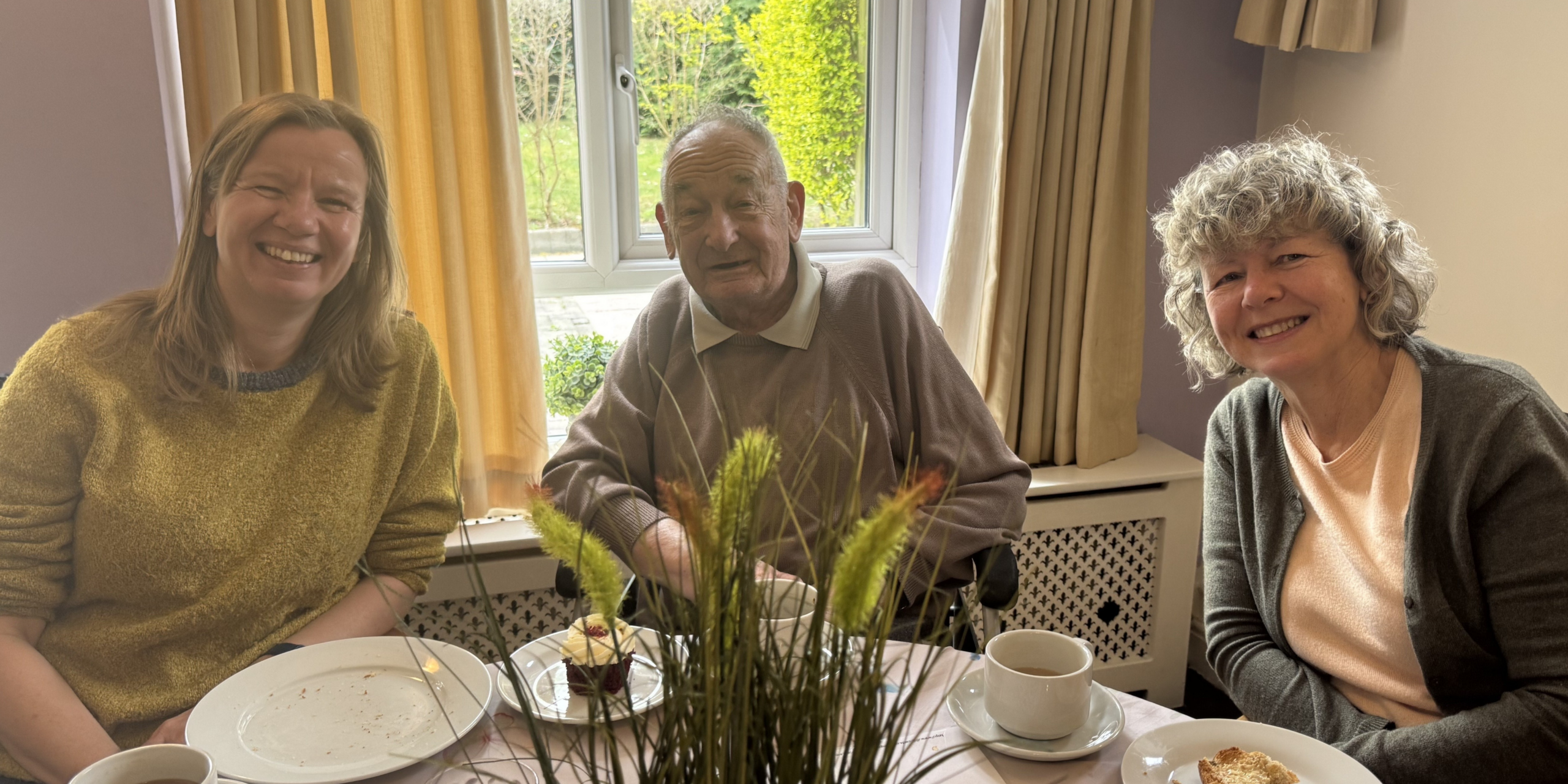 Family having tea together at Robert Harvey House