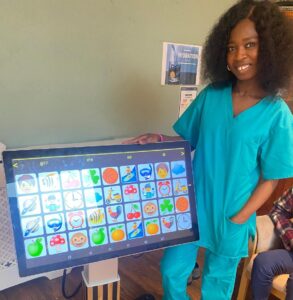 Tomi, activities lead at Anita Stone Court, with the interactive TV at Anita Stone Court