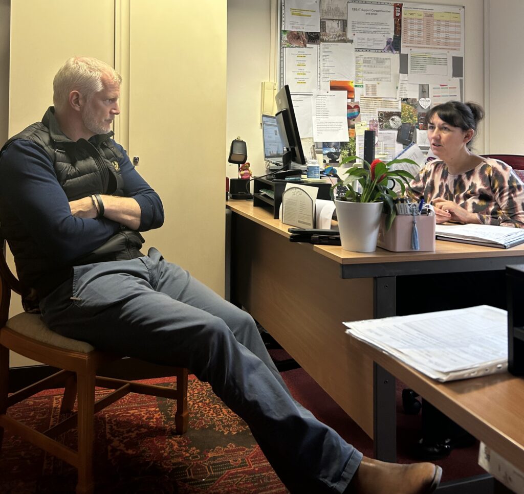 MP Al Carns talks with Neville Williams House general manager Amy Beasley