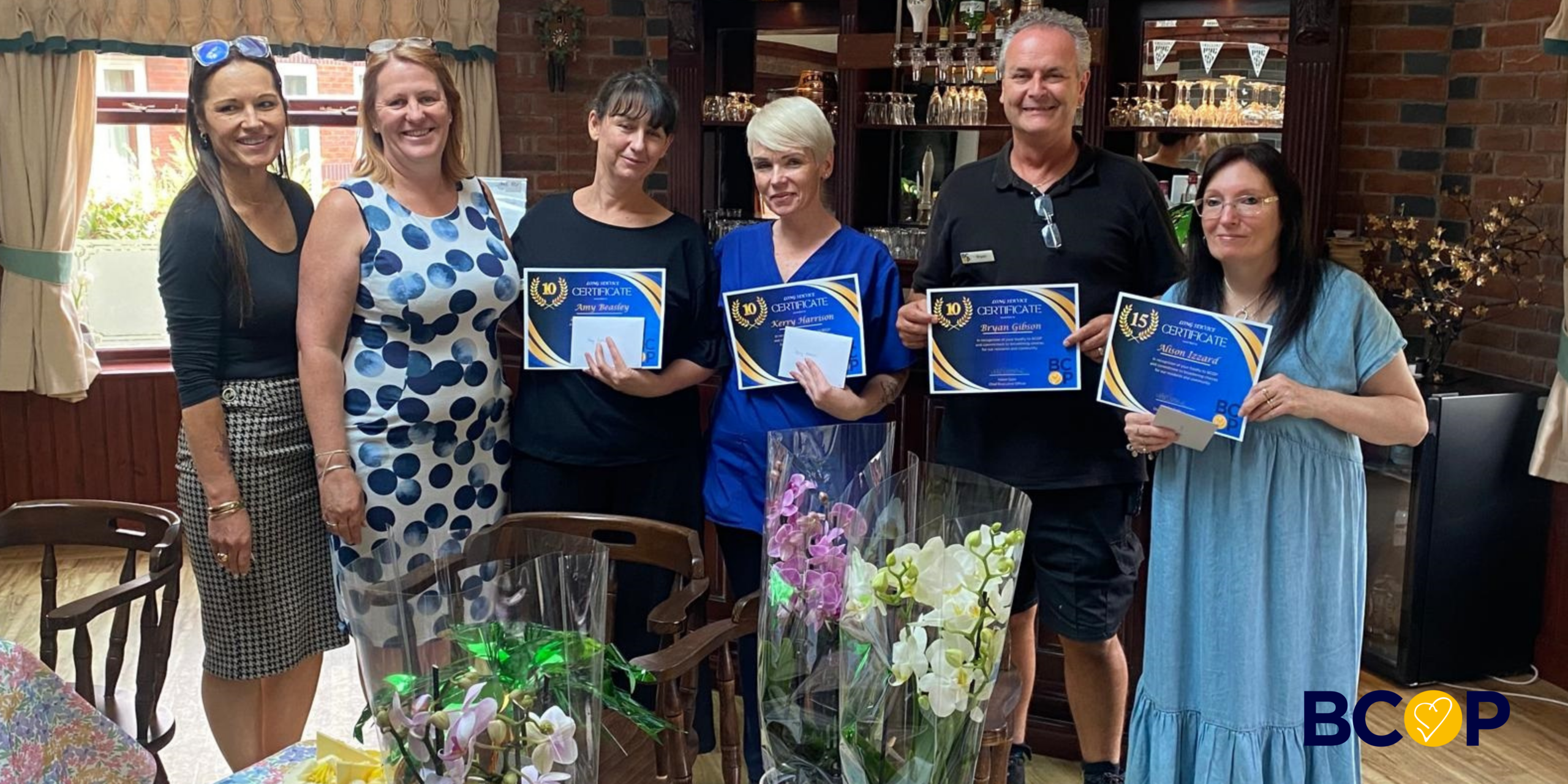 Staff from neville Williams house nd Anita Stone Court receive their long service awards